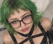 A second portrait with green hair and glasses.